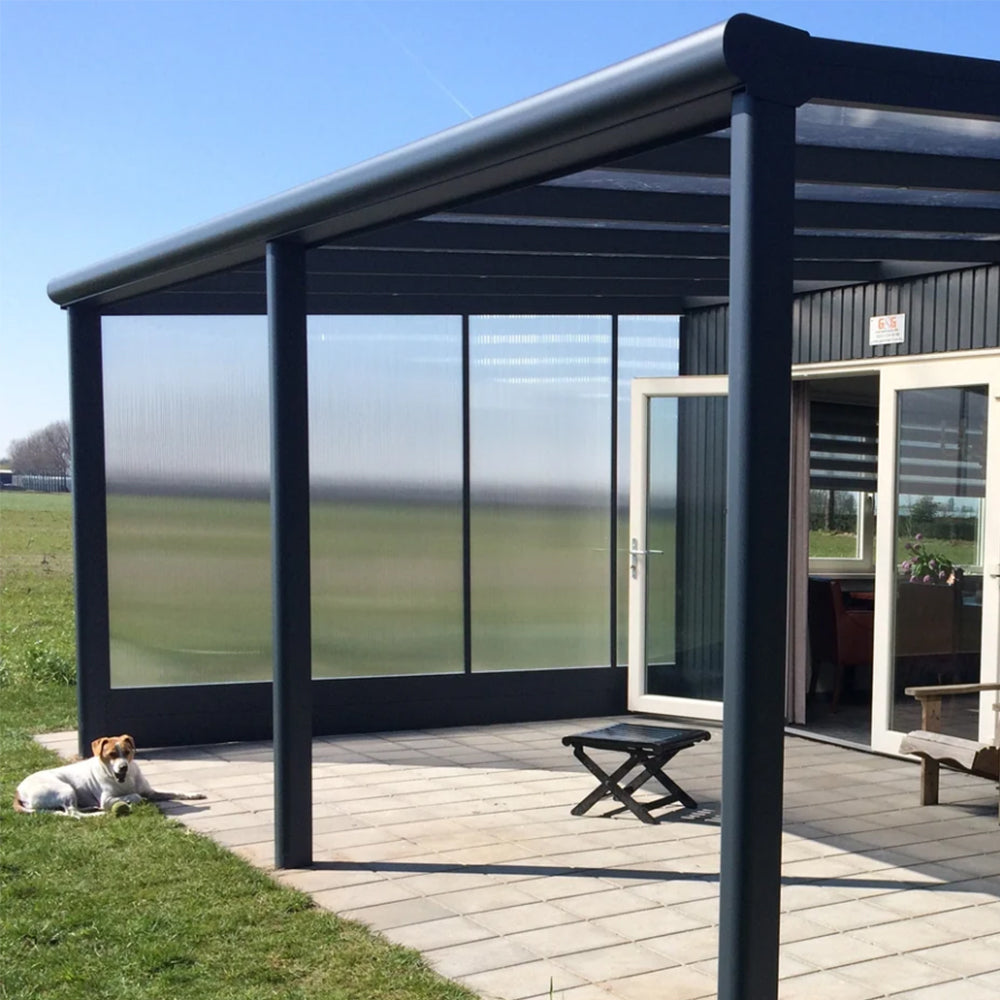 Modern outdoor canopy with side wall panels on a sunny day, featuring a dog lying on the grass.