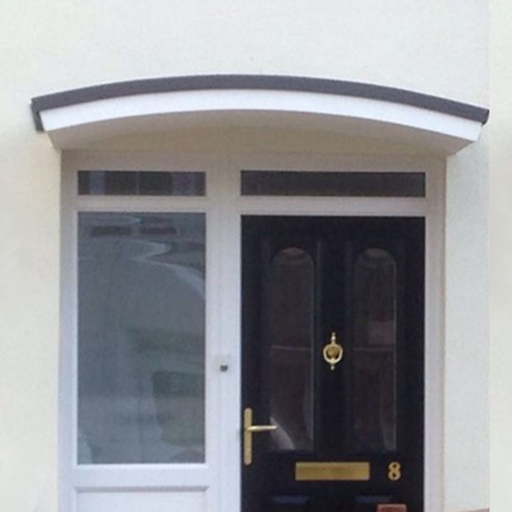 house entrance with black door and white window sheltered by curved cherwell overdoor canopy