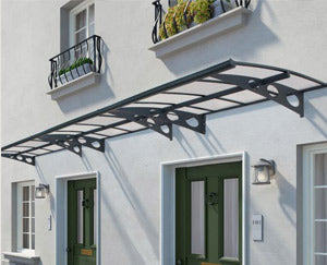 anthracite grey metal canopy over a white building entrance with decorative brackets.