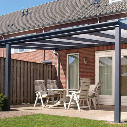 Outdoor patio with aluminium pergola, table, and chairs in front of a brick house.