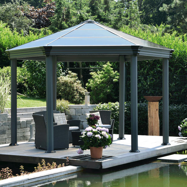 stunning garden with gazebo covering seating area by a pond
