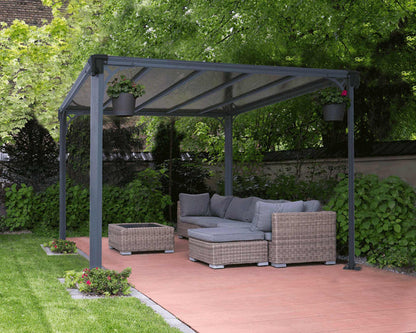 Outdoor patio with aluminium gazebo covering sofas and table in a garden setting