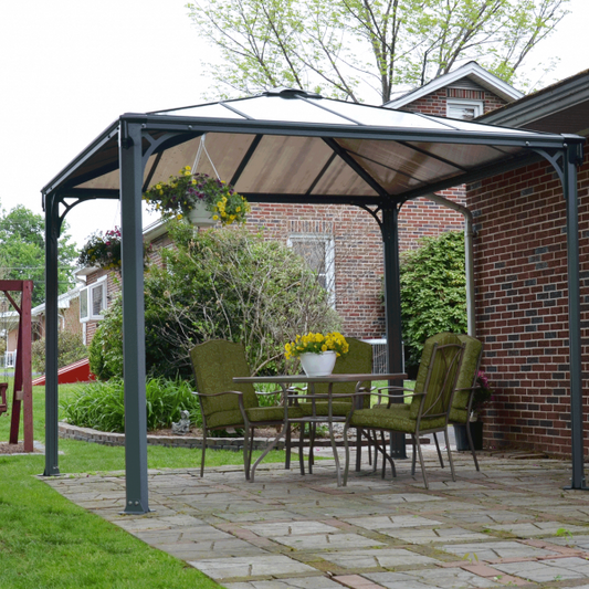 gazebo covering a dining area over paving next to house