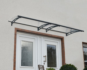 Decorative metal canopy over a white front door on a light gray wall