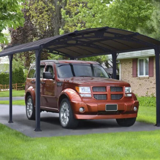 orange SUV parked under an aluminium crescent carport with a house and trees in the background